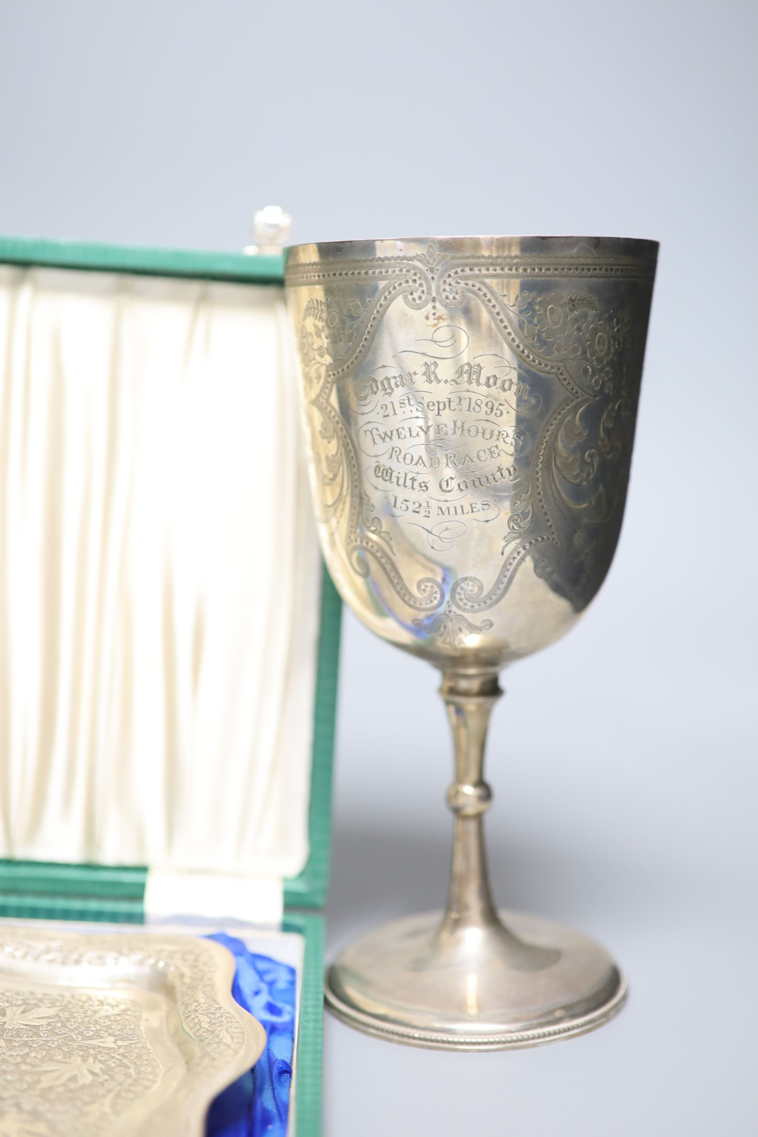 A Victorian engraved silver trophy cup, 'Twelve Hours Road Race', 1895, two small silver trophy cups and an embossed white metal presentation tray